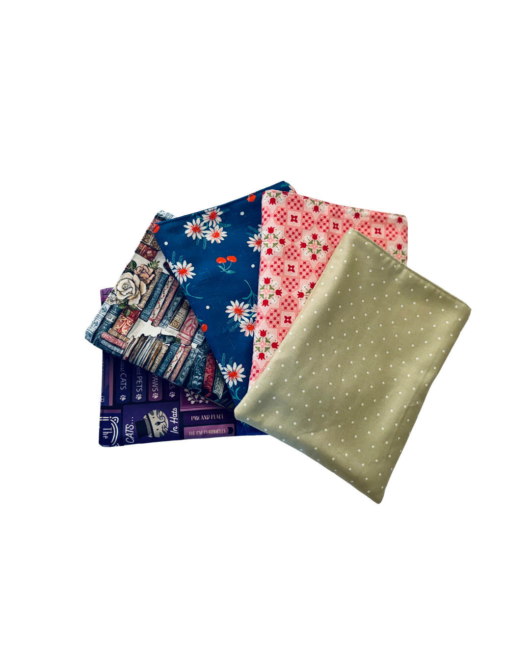 5 e-reader sleeves arranged on a white background. Fabric patterns left to right: purple cat-themed book print; stacked blue/white/pink books with roses; cherries and daisies on blue; pink floral lattice; sage polka dots.