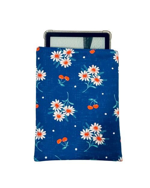 kindle inside Floral patterned e-reader sleeve with white daisies and red cherries on a blue fabric with a white background