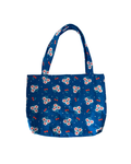blue tote bag with red cherry and white floral print against a white background