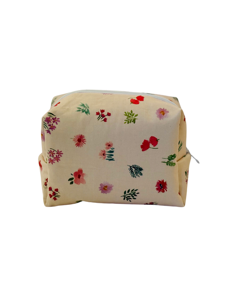 pink Floral-patterned cosmetic bag with a white zipper on a light background