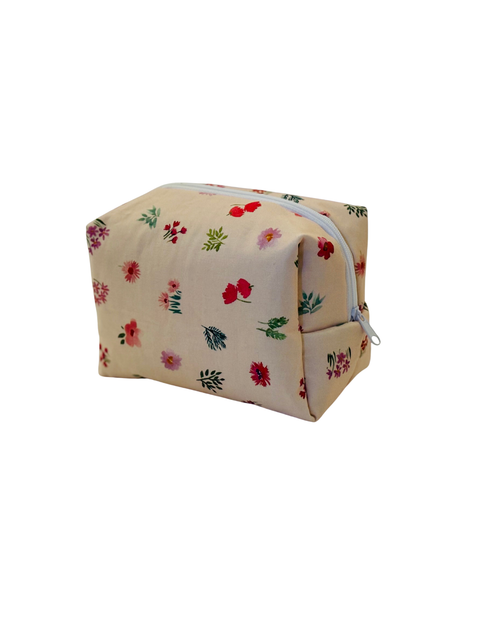 pink Floral-patterned cosmetic bag with a white zipper on a light background