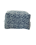 white and navy Floral-patterned toiletry bag with a white zipper on a white background