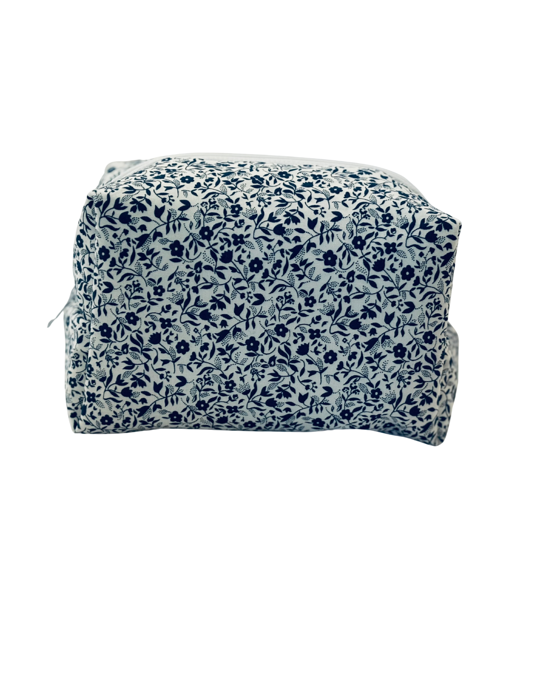 white and navy Floral-patterned toiletry bag with a white zipper on a white background