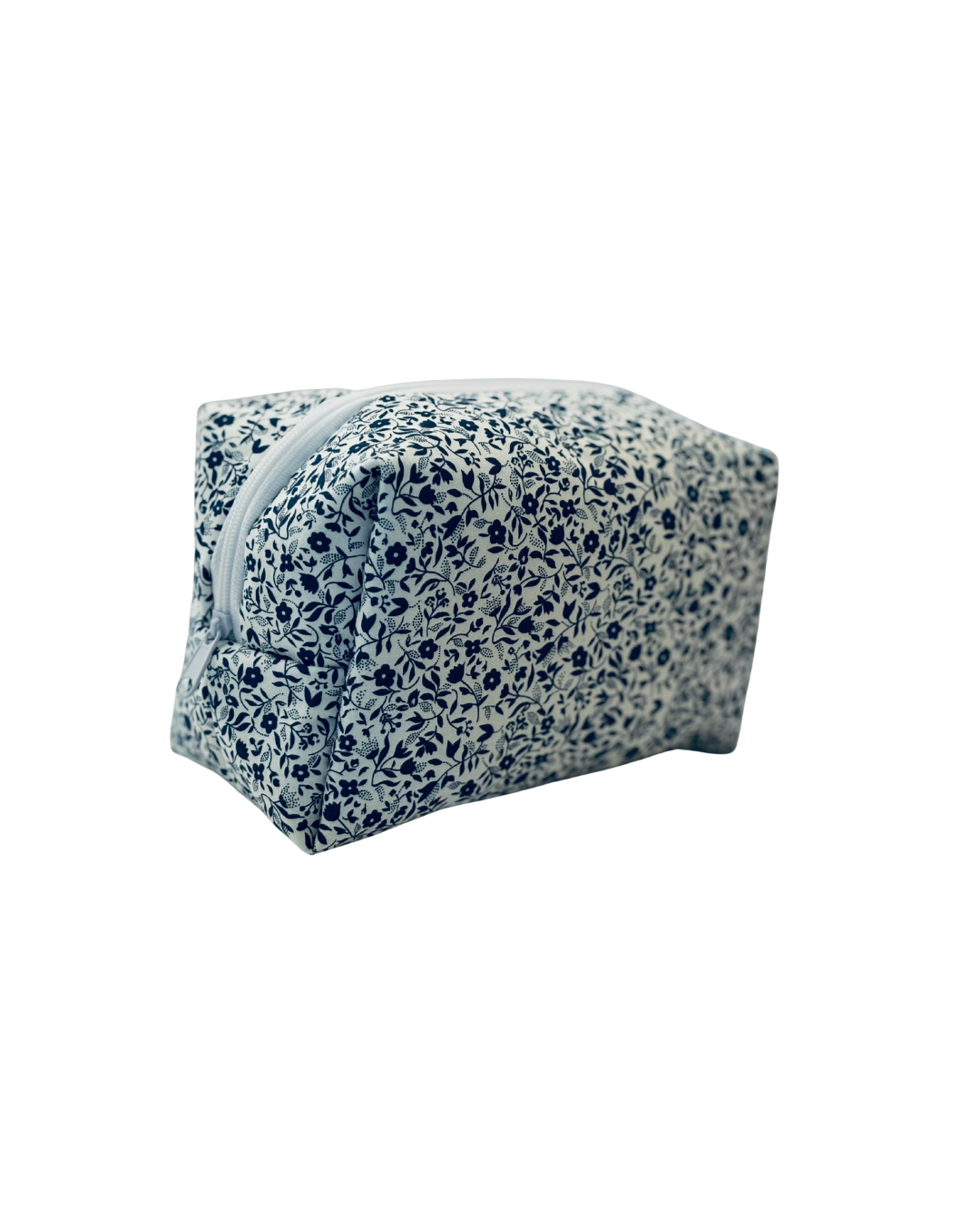 white and navy Floral-patterned toiletry bag with a white zipper on a white background