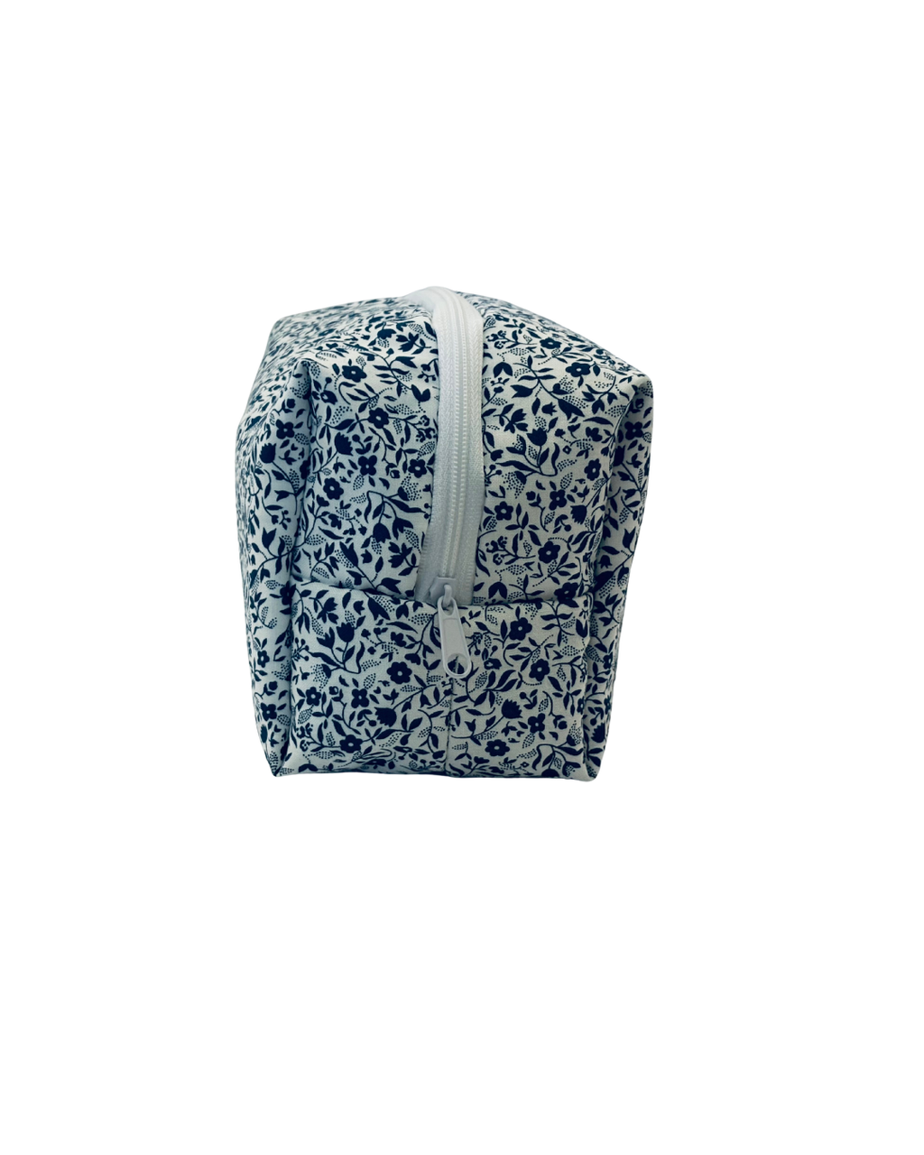 white and navy Floral-patterned toiletry bag with a white zipper on a white background