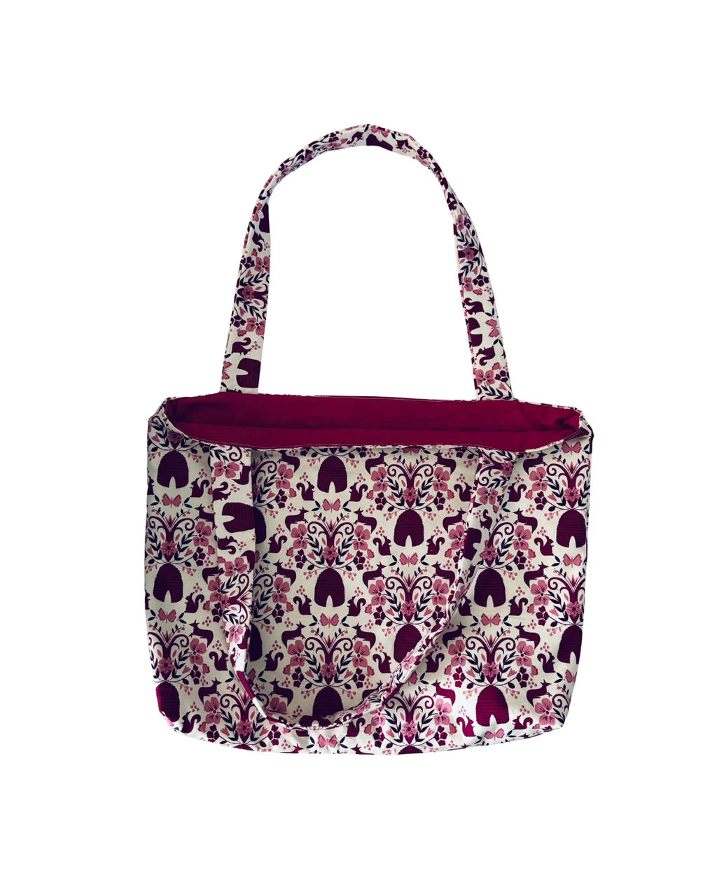 white tote bag with purple woodland print with purple interior against white background