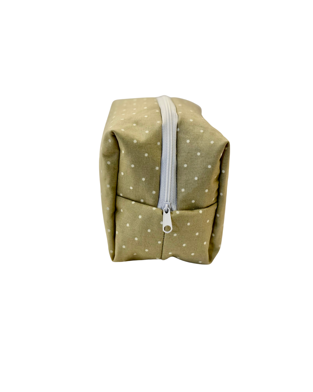 Green polka dot pouch with a white zipper on a white background