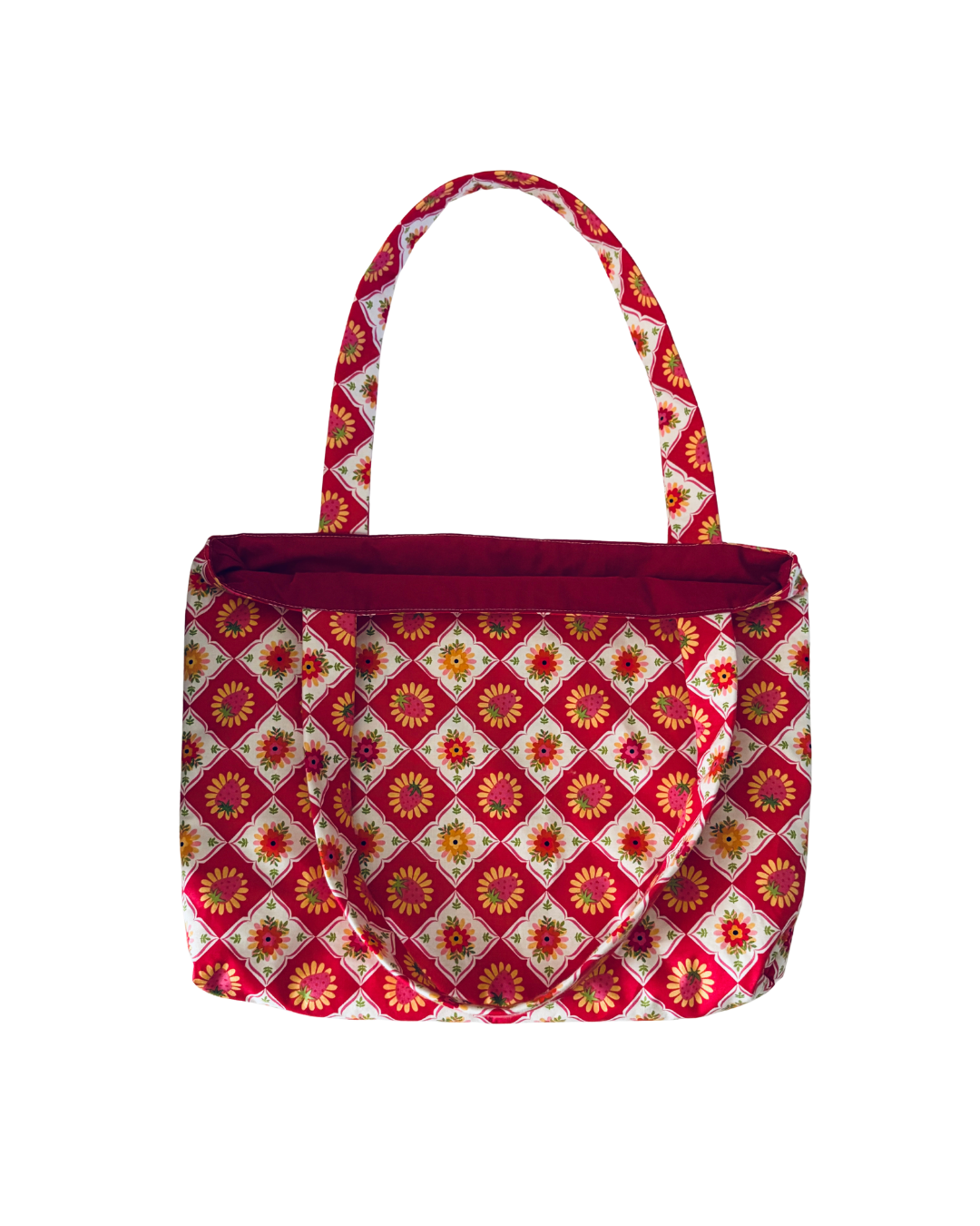 red, pink, and white strawberry lattice pattern tote bag with pink interior against white background
